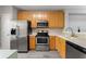 Kitchen with wooden cabinets, countertops, and modern appliances at 1178 Vineland Pl, Lake Mary, FL 32746