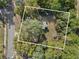 Aerial view of the property showing lush, mature trees and other buildings nearby at 1208 Bonaire Dr, Leesburg, FL 34748