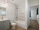 Updated bathroom features a tub with marble-style tile surround, modern lighting, and new vanity at 1208 Bonaire Dr, Leesburg, FL 34748