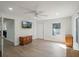 Comfortable bedroom featuring modern ceiling fan and wood-look floors at 1208 Bonaire Dr, Leesburg, FL 34748