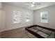 Spacious bedroom with three windows allowing for ample natural light and new floors at 1208 Bonaire Dr, Leesburg, FL 34748