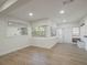 Open concept living area featuring wood-look floors and a large window view at 1208 Bonaire Dr, Leesburg, FL 34748