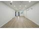 Bright living room with wood-look floors and recessed lighting at 1208 Bonaire Dr, Leesburg, FL 34748