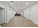 Spacious living room with wood-look floors and recessed lighting at 1208 Bonaire Dr, Leesburg, FL 34748