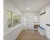 Bright and airy sun room with large windows, bench seating, and tile floors at 1208 Bonaire Dr, Leesburg, FL 34748