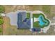 Aerial view of a luxurious estate with a sprawling layout, inground pool, and lush greenery at 12323 Sweet Hill Rd, Polk City, FL 33868