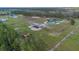 Expansive property featuring a modern home with a pool, large workshop, and abundant surrounding greenery at 12323 Sweet Hill Rd, Polk City, FL 33868