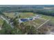Large property showcasing a home with a pool, a separate workshop, and surrounding woodlands at 12323 Sweet Hill Rd, Polk City, FL 33868