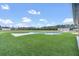 Expansive backyard features a sparkling in-ground pool, lush lawn, and ample space for outdoor enjoyment at 12323 Sweet Hill Rd, Polk City, FL 33868