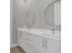Bathroom featuring double sink, modern fixtures and a white cabinet at 12323 Sweet Hill Rd, Polk City, FL 33868