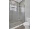 Modern bathroom featuring a large glass shower with chrome hardware and a bright white toilet at 12323 Sweet Hill Rd, Polk City, FL 33868