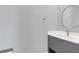 A half bathroom features a gray cabinet, modern sink and updated fixtures at 12323 Sweet Hill Rd, Polk City, FL 33868