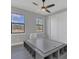A bright bedroom features a unique bed frame, natural light and a ceiling fan at 12323 Sweet Hill Rd, Polk City, FL 33868