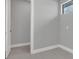 Empty room with light grey walls, white trim, and a window to let in natural light at 12323 Sweet Hill Rd, Polk City, FL 33868