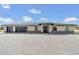 Single-story home featuring a wide driveway, three-car garage, and neutral color scheme at 12323 Sweet Hill Rd, Polk City, FL 33868