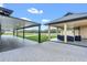 Exterior view of covered patios with modern furniture and a pool in the backyard at 12323 Sweet Hill Rd, Polk City, FL 33868
