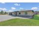 Beautifully landscaped home with stone accents, a three-car garage and a paver driveway at 12323 Sweet Hill Rd, Polk City, FL 33868