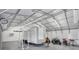 Large, metal shop building contains gym equipment, trailer, and multiple 4-wheelers at 12323 Sweet Hill Rd, Polk City, FL 33868