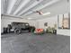 Spacious garage with a parked vehicle, tiled floor, and ample storage space at 12323 Sweet Hill Rd, Polk City, FL 33868