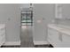 Bright hallway leading to the backyard with access to the outdoor pool, plus bright white cabinets at 12323 Sweet Hill Rd, Polk City, FL 33868