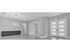 Bright, open living room featuring stylish light fixtures, a gray accent wall, and modern tile flooring at 12323 Sweet Hill Rd, Polk City, FL 33868