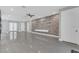 Open-concept living space with a stone accent wall and a ceiling fan, complemented by elegant tile flooring at 12323 Sweet Hill Rd, Polk City, FL 33868