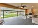 Outdoor kitchen featuring a sink, grill, counter space and a view of the pool at 12323 Sweet Hill Rd, Polk City, FL 33868