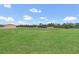 Sprawling acreage features a large green lawn and a workshop at 12323 Sweet Hill Rd, Polk City, FL 33868