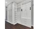 Large walk-in closet with bright white built-in shelving, drawers, and hanging rods at 12323 Sweet Hill Rd, Polk City, FL 33868