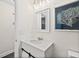 Clean bathroom boasts a modern vanity, contemporary framed mirror, and updated lighting fixtures above the sink at 124 Oakridge Ave, Edgewater, FL 32132