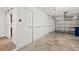 The home features an oversized garage with overhead storage, shelving, and access to the home's kitchen at 124 Oakridge Ave, Edgewater, FL 32132