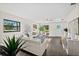 Bright living room with modern decor, stylish furnishings, and dark wood-look flooring at 124 Oakridge Ave, Edgewater, FL 32132