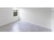 Bright bedroom with gray tile flooring and a large window providing ample natural light at 13687 Sw 33Rd Cir, Ocala, FL 34473