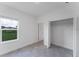 Bright bedroom featuring an open closet and a large window with tile floor at 13687 Sw 33Rd Cir, Ocala, FL 34473