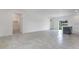 Open-concept living room with tile floors leading to the kitchen and bathroom area featuring a shower and bathtub at 13687 Sw 33Rd Cir, Ocala, FL 34473