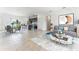 The open-concept living space features tile floors, modern furnishings, and a view of the kitchen at 13687 Sw 33Rd Cir, Ocala, FL 34473