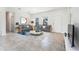 Bright living area featuring neutral walls, tile flooring, contemporary furnishings, and natural light at 13687 Sw 33Rd Cir, Ocala, FL 34473