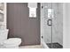 Modern bathroom with textured wall, window, and glass enclosed shower with marble look tiling at 1401 W Highway 50 # 45, Clermont, FL 34711