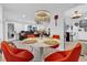 Charming dining area next to living room, featuring stylish chandelier and seating for four at 1401 W Highway 50 # 45, Clermont, FL 34711