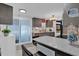 Modern kitchen with granite countertops, breakfast bar, and sliding door access to patio at 1401 W Highway 50 # 45, Clermont, FL 34711