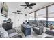 Relaxing sunroom featuring wicker furniture, a gas fire table, a fan, and an outdoor view at 1401 W Highway 50 # 45, Clermont, FL 34711