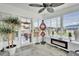 Relaxing sunroom featuring ceramic tile, fireplace, modern decorations, and plenty of sunlight at 1401 W Highway 50 # 45, Clermont, FL 34711