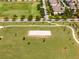 The aerial shot of a community park boasts a sand volleyball court, walking paths, and open green spaces for leisure at 15580 Blackbead St, Winter Garden, FL 34787