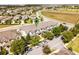 Aerial view of townhomes with attached garages and mature trees in a Primary-planned community at 15580 Blackbead St, Winter Garden, FL 34787