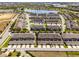 A scenic aerial view of a community featuring stylish townhomes near a serene lake and lush landscaping at 15580 Blackbead St, Winter Garden, FL 34787
