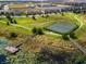 Aerial showcasing neighborhood tennis courts, a fishing pier, and stunning water views at 15580 Blackbead St, Winter Garden, FL 34787