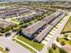 Aerial view of townhomes with ample parking and community greenspaces in neighborhood at 15580 Blackbead St, Winter Garden, FL 34787