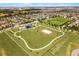 An aerial perspective of a community park with a playground, sports area, and walking path, ideal for recreation at 15580 Blackbead St, Winter Garden, FL 34787