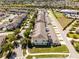 Aerial view of townhome community featuring street parking and landscaped lawns at 15580 Blackbead St, Winter Garden, FL 34787