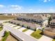 Aerial view of townhomes showcasing modern architecture and neatly landscaped grounds at 15580 Blackbead St, Winter Garden, FL 34787